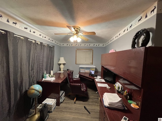 office with a textured ceiling, hardwood / wood-style flooring, and ceiling fan