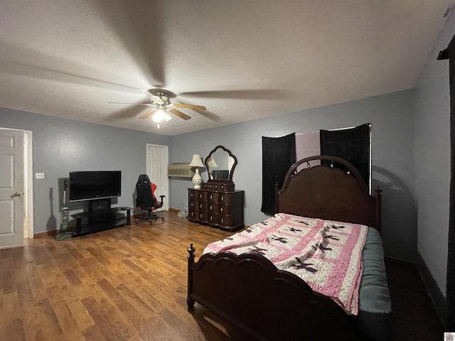 bedroom with ceiling fan and wood-type flooring