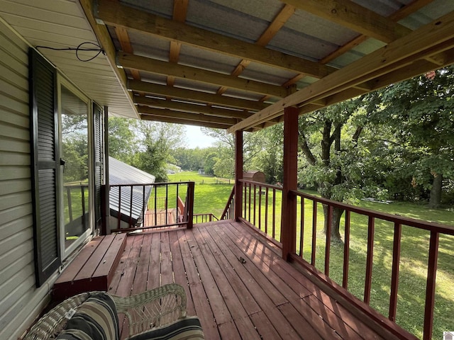 wooden terrace featuring a yard