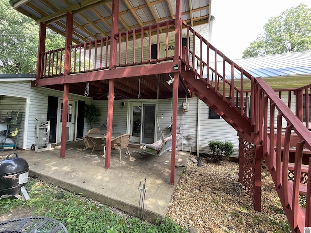 exterior space featuring a wooden deck and a patio area