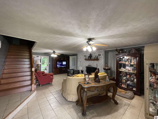 tiled living room with a textured ceiling, a brick fireplace, and ceiling fan