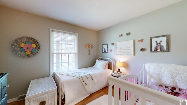 bedroom with hardwood / wood-style floors