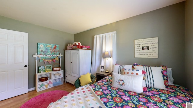 bedroom with hardwood / wood-style floors