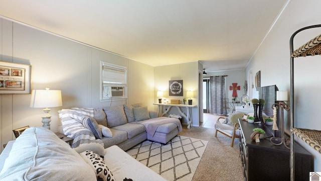 living room featuring a wealth of natural light, cooling unit, and light colored carpet