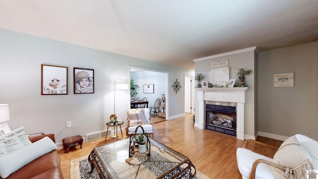 living room featuring crown molding and wood-type flooring