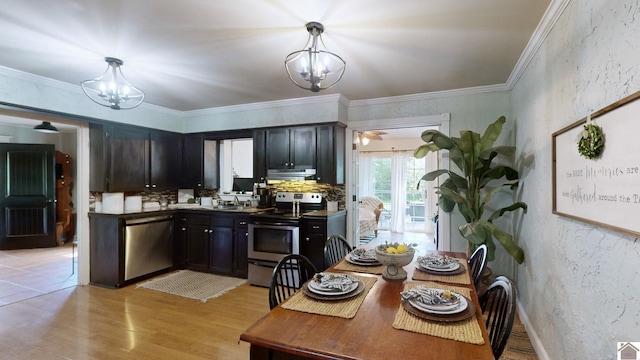 kitchen featuring a chandelier, hanging light fixtures, stainless steel appliances, and light hardwood / wood-style flooring