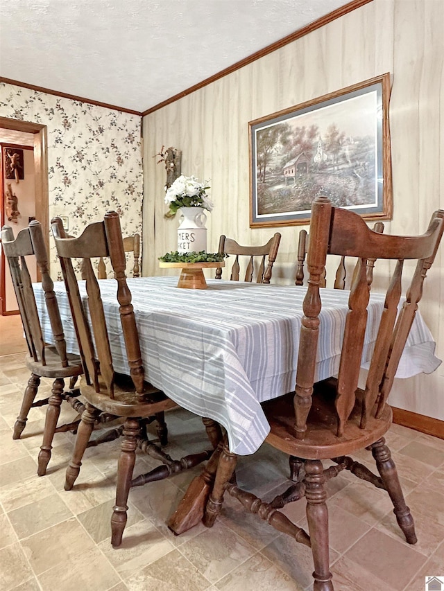 dining area with a textured ceiling and ornamental molding