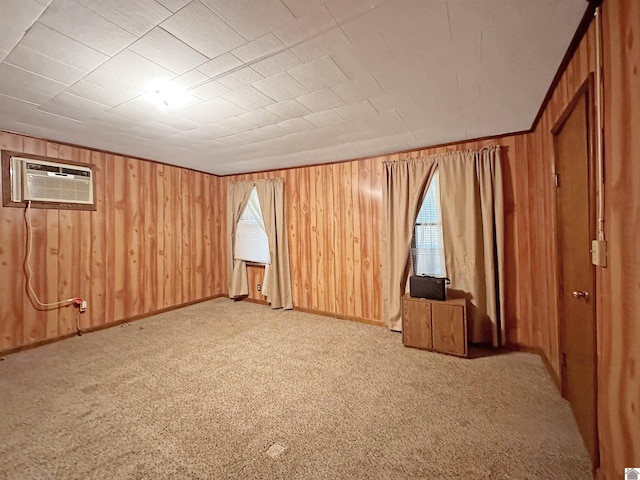 spare room with a wall mounted air conditioner and light carpet