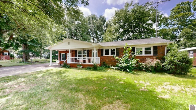 ranch-style house featuring a porch and a front yard