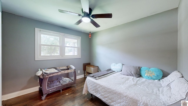 bedroom with ceiling fan and dark wood-type flooring