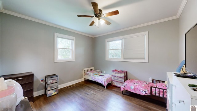 bedroom featuring multiple windows, dark hardwood / wood-style floors, ceiling fan, and ornamental molding