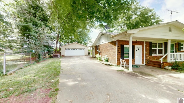 view of front of property with an outbuilding, covered porch, and a garage