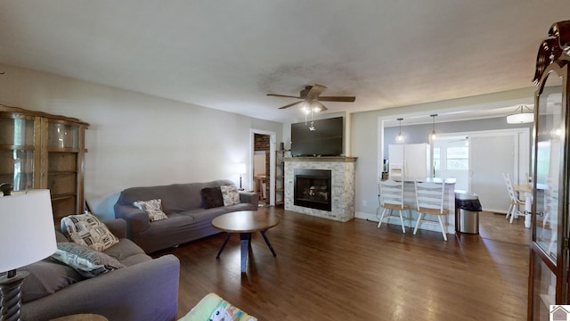 living room featuring ceiling fan and dark hardwood / wood-style flooring