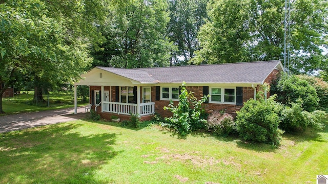 ranch-style house featuring a porch and a front yard