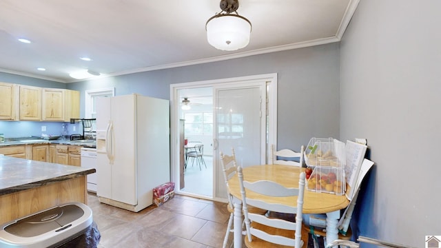 kitchen featuring light tile patterned floors, white appliances, ornamental molding, and light brown cabinetry