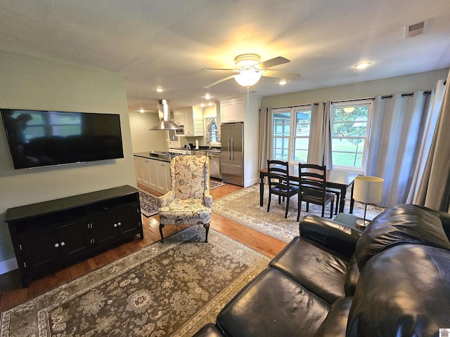 living room with hardwood / wood-style flooring and ceiling fan