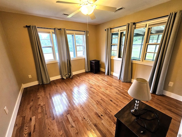 empty room featuring hardwood / wood-style flooring and ceiling fan