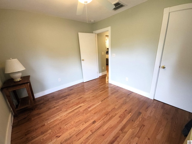 unfurnished bedroom with wood-type flooring and ceiling fan