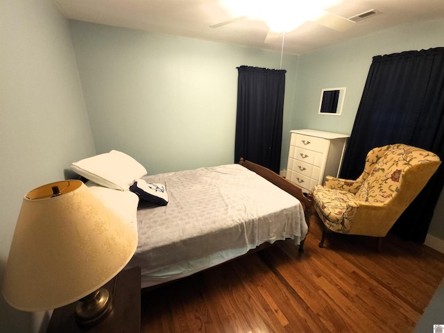 bedroom featuring ceiling fan and dark hardwood / wood-style floors