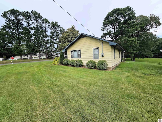 view of home's exterior with a yard