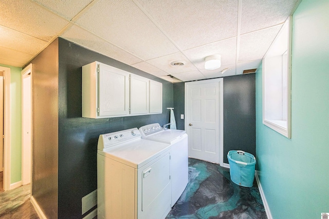 laundry area with separate washer and dryer and cabinets