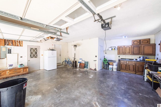 garage with a garage door opener and white fridge