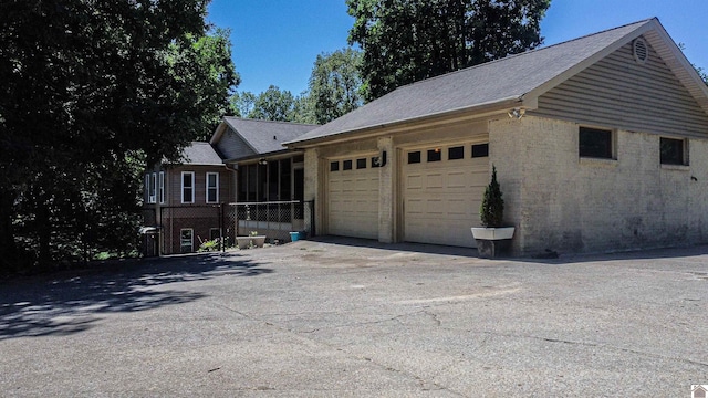 view of side of home featuring a garage