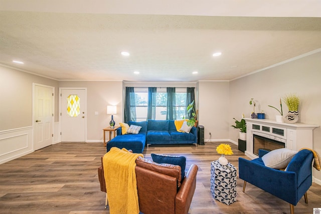 living room with ornamental molding, hardwood / wood-style floors, and a textured ceiling