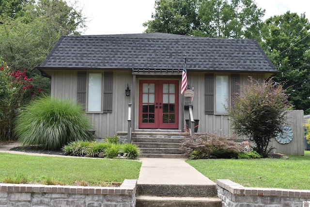 exterior space featuring french doors and a lawn