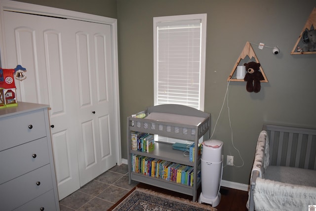 bedroom with a nursery area and a closet