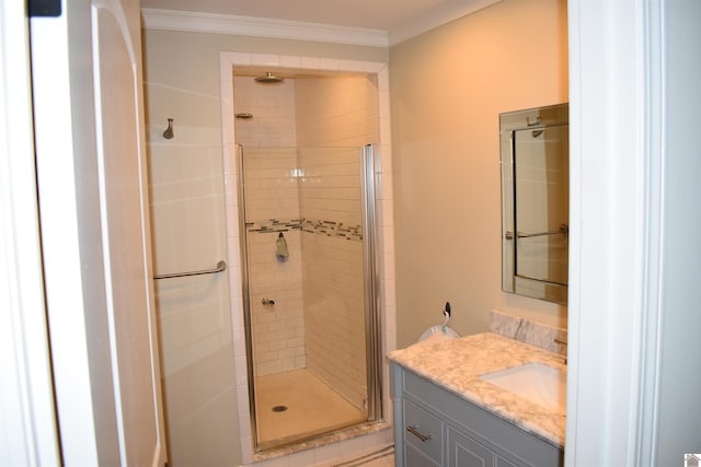 bathroom with ornamental molding, an enclosed shower, and vanity