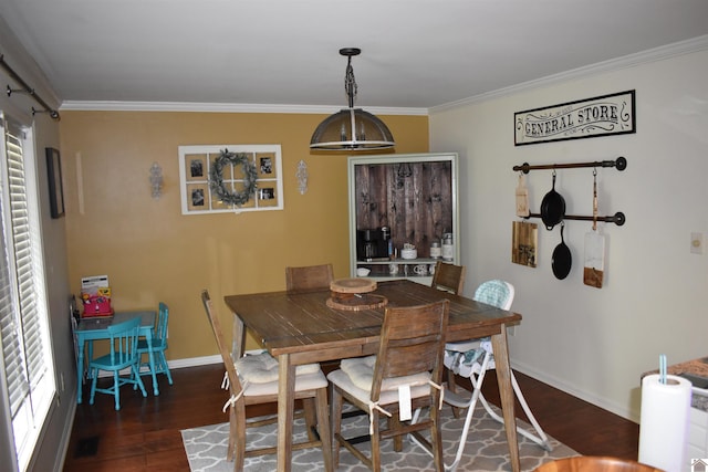 dining room with crown molding and dark hardwood / wood-style flooring