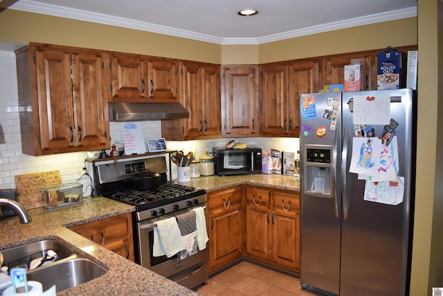 kitchen with sink, backsplash, stainless steel appliances, and light stone countertops