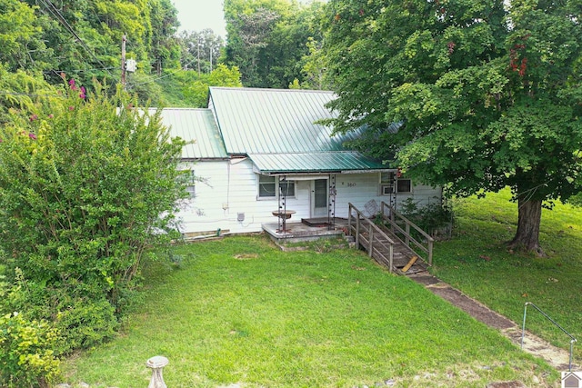 exterior space with covered porch and a front yard