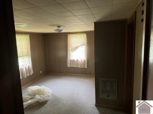 unfurnished room with a drop ceiling and carpet flooring