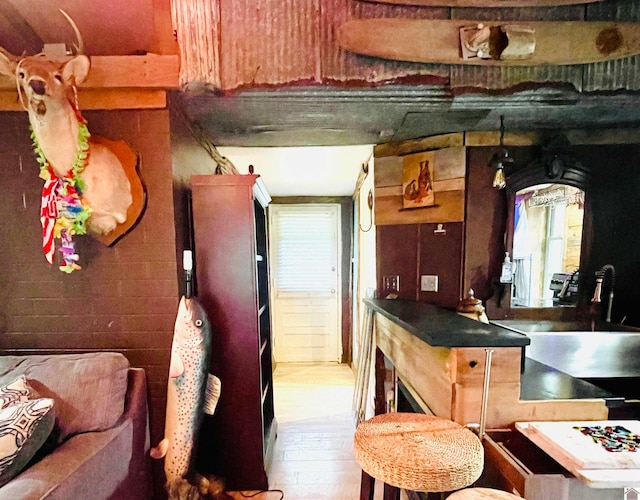 kitchen with a fireplace and hardwood / wood-style floors