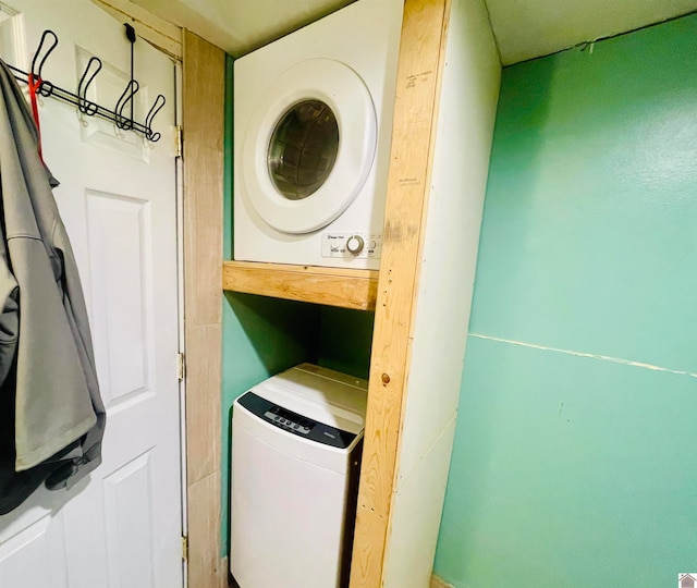 laundry area with stacked washing maching and dryer