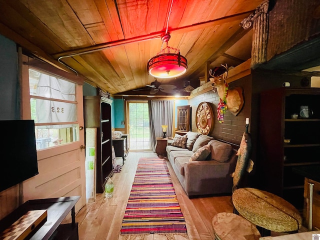 living room with ceiling fan, hardwood / wood-style floors, and wood ceiling