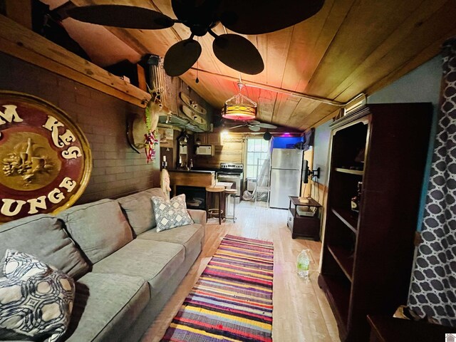 living room with wood walls, sink, vaulted ceiling, light hardwood / wood-style floors, and wood ceiling