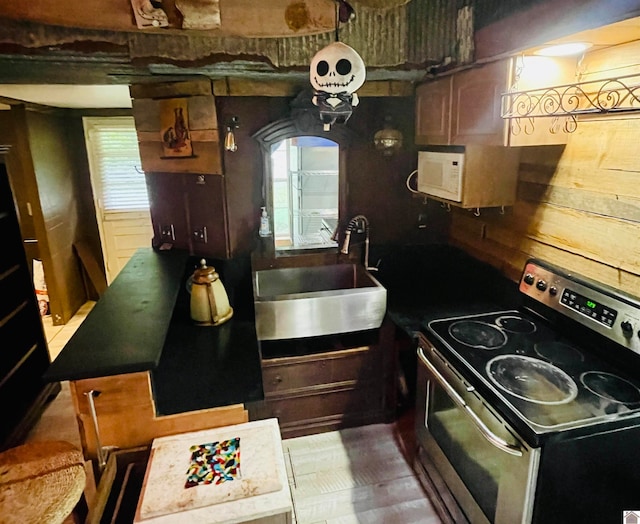 kitchen with sink, stainless steel electric stove, and a healthy amount of sunlight