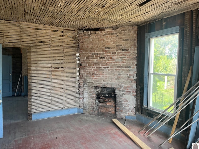 unfurnished living room with a brick fireplace