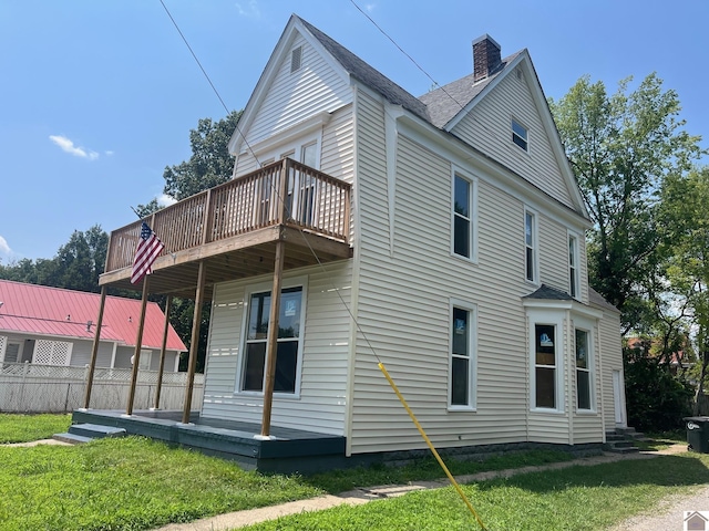 back of house with a yard and a wooden deck