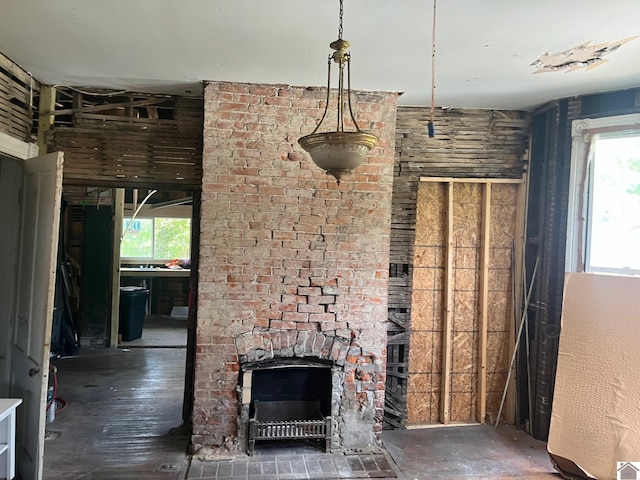 unfurnished living room with a fireplace and a healthy amount of sunlight