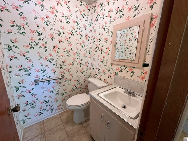 bathroom with vanity, toilet, and tile patterned floors