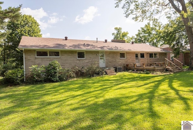 back of property with a lawn, central AC, and a deck