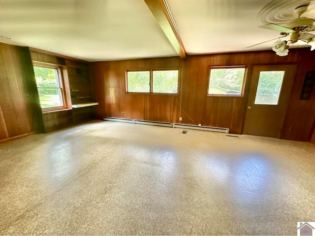 interior space with a wealth of natural light, ceiling fan, beamed ceiling, and wooden walls