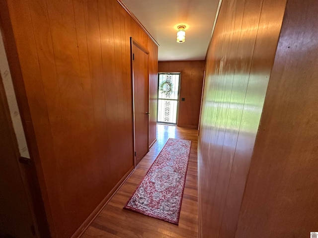 corridor featuring wooden walls and hardwood / wood-style flooring