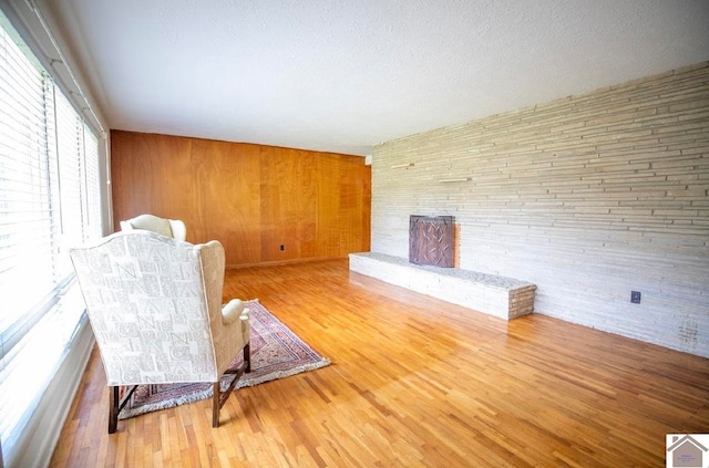 unfurnished room featuring wood-type flooring and wood walls