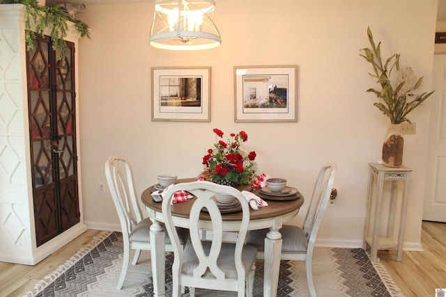 dining space with light hardwood / wood-style floors