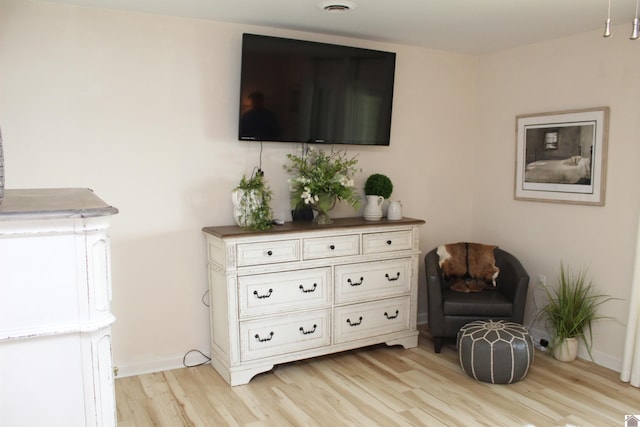 sitting room with light wood-style flooring and baseboards